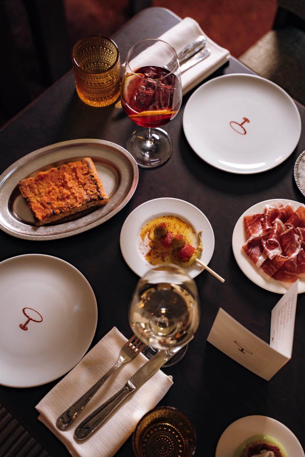 Een tafel vol tapas, wijn en borden van Mesa Mesa