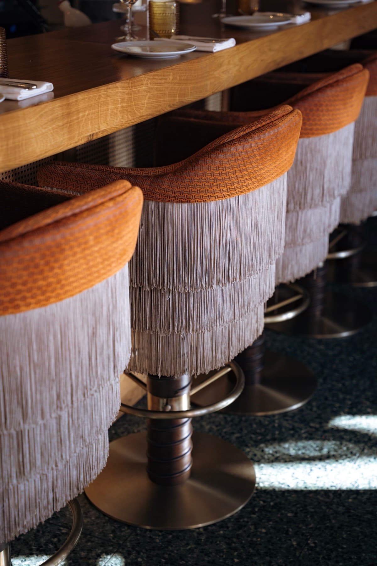 Fringed bar stools in terracotta velvet