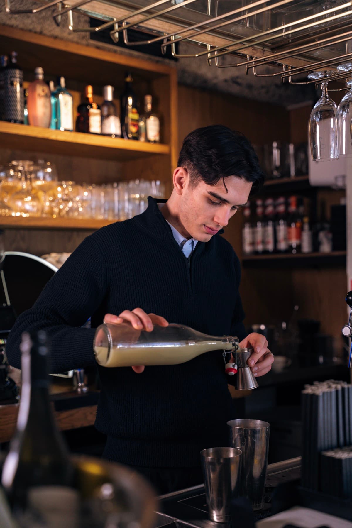 The bartender pouring a cocktail