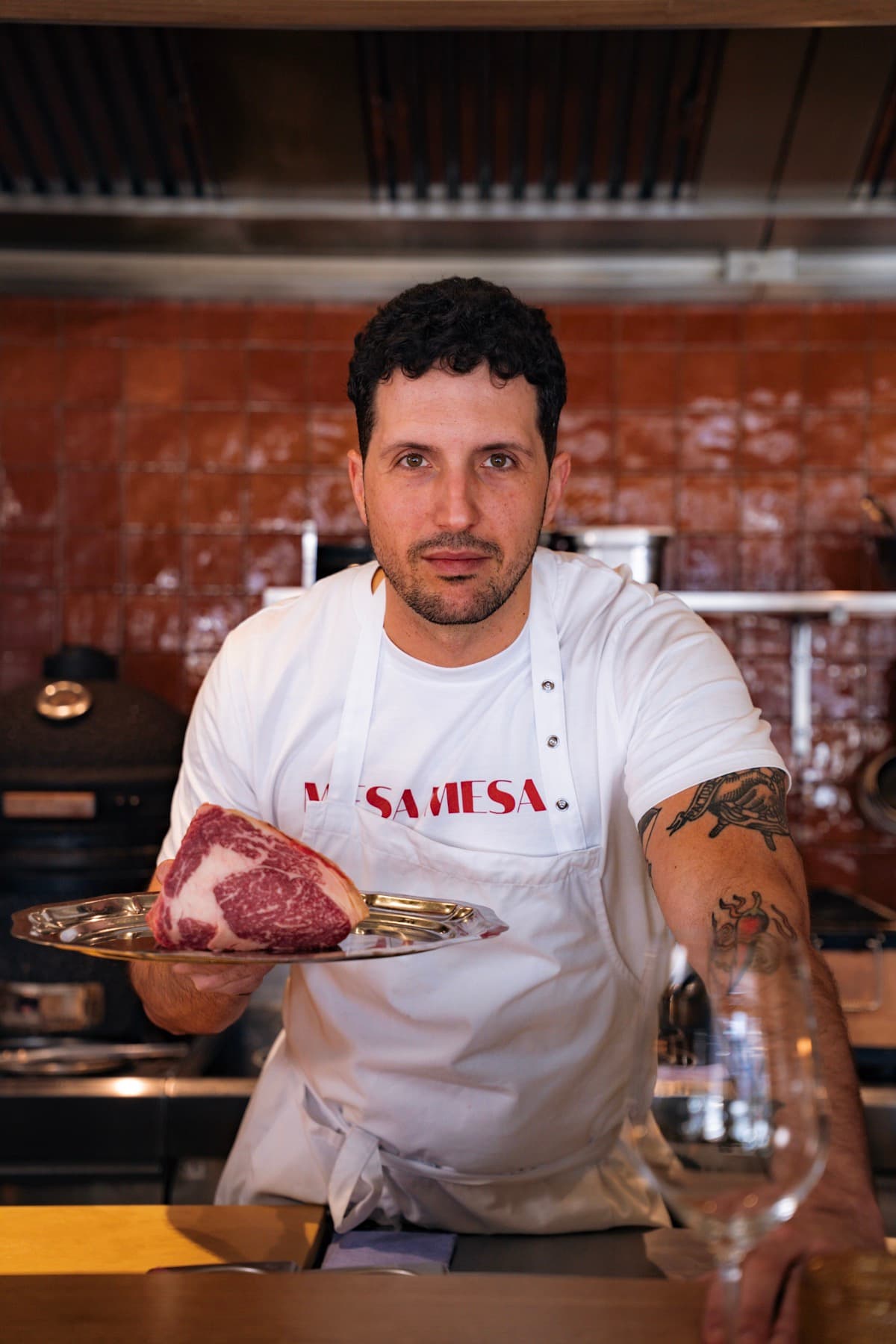 The chef presenting a seared steak